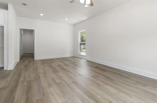 spare room featuring ceiling fan and light hardwood / wood-style flooring