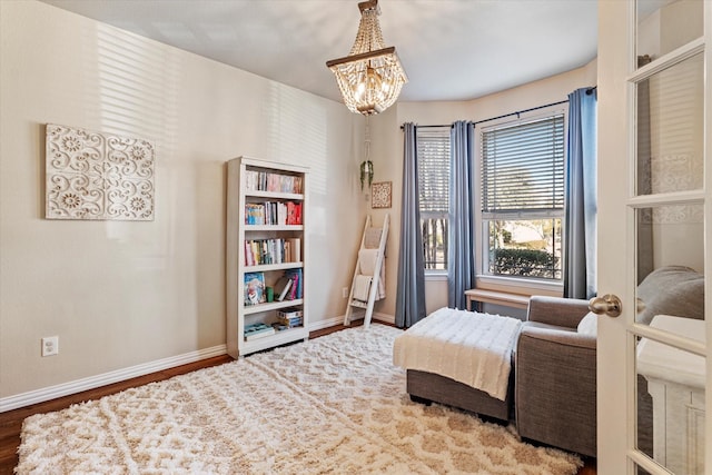 bedroom featuring wood-type flooring and a chandelier