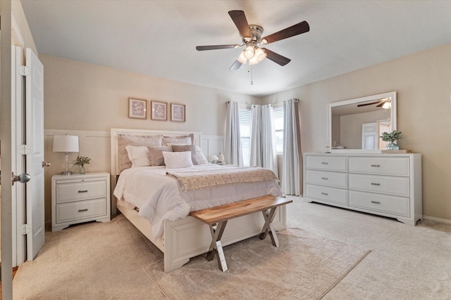 bedroom featuring light carpet and ceiling fan