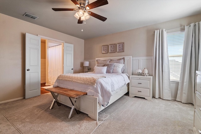 bedroom featuring ceiling fan and light carpet