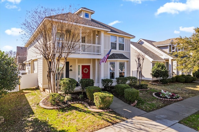 view of front of property featuring a balcony and a porch