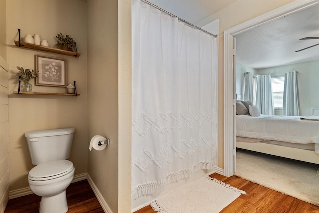 bathroom with ceiling fan, hardwood / wood-style flooring, and toilet