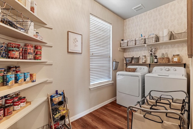 laundry area featuring washing machine and clothes dryer and dark hardwood / wood-style floors