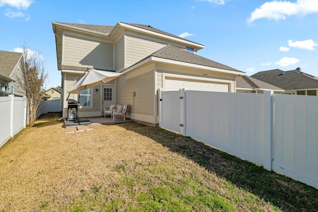 back of property with a patio and a yard