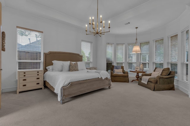 carpeted bedroom featuring multiple windows, a notable chandelier, a tray ceiling, and ornamental molding