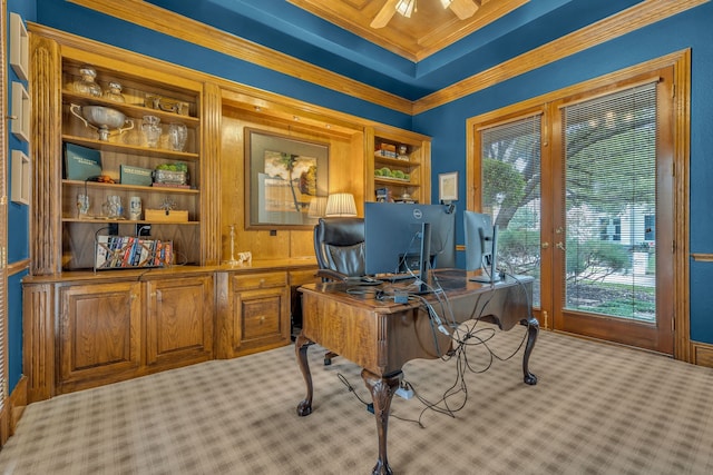 carpeted office space with crown molding and ceiling fan