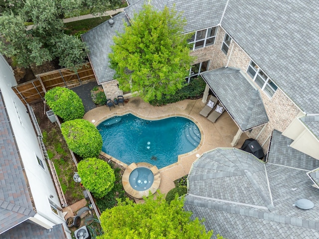 view of swimming pool with a patio and a grill