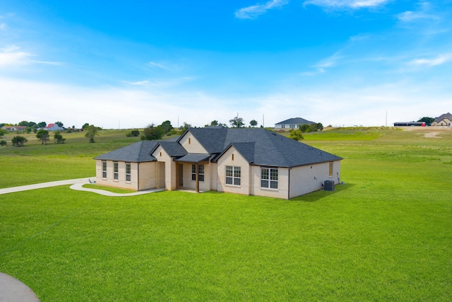 view of front of house featuring central AC and a front yard