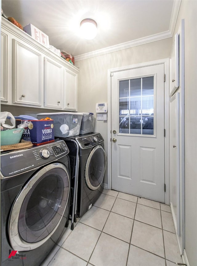 clothes washing area with washer and dryer, light tile patterned floors, ornamental molding, and cabinets