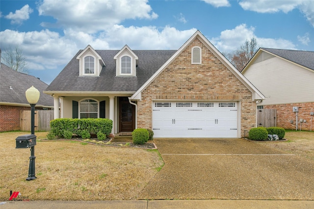 view of front of property featuring a garage and a front lawn