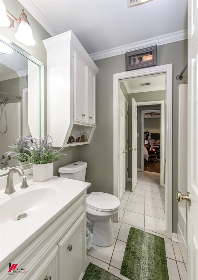 bathroom featuring tile patterned floors, toilet, a shower, crown molding, and vanity