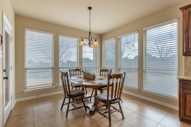 dining area featuring an inviting chandelier and light tile patterned floors