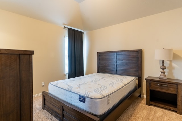 carpeted bedroom with vaulted ceiling