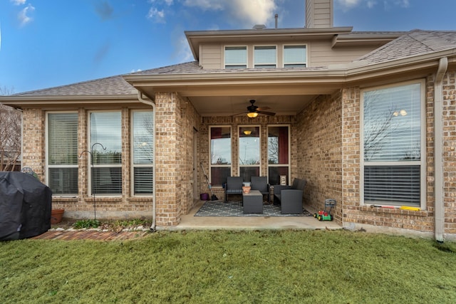 rear view of house with ceiling fan, a yard, outdoor lounge area, and a patio