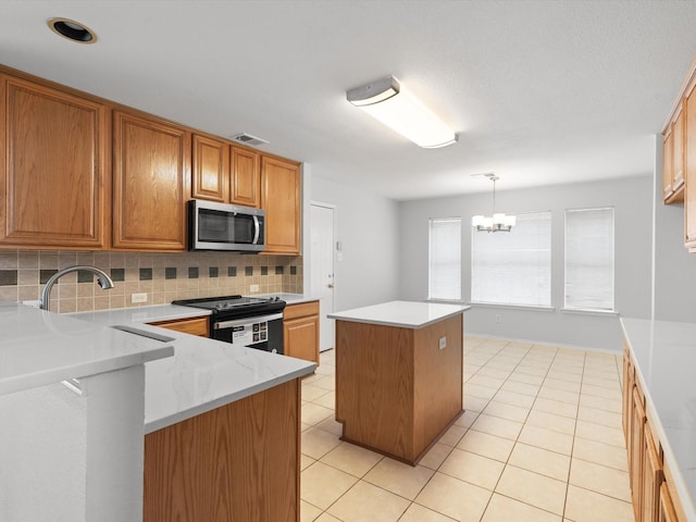 kitchen with hanging light fixtures, light tile patterned floors, electric range, a kitchen island, and decorative backsplash