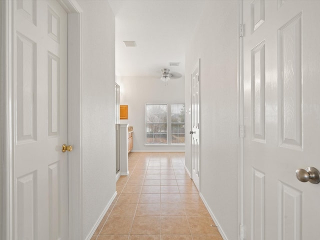 2425 Brycewood Ln, Plano, TX 75025 - hallway with light tile patterned floors and baseboards