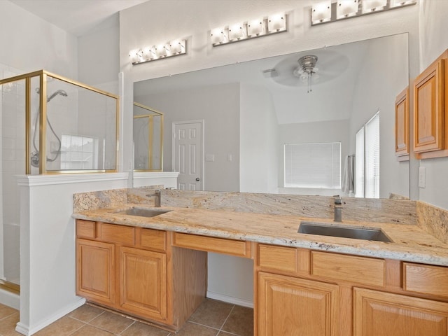 bathroom with tile patterned flooring, vanity, ceiling fan, and walk in shower