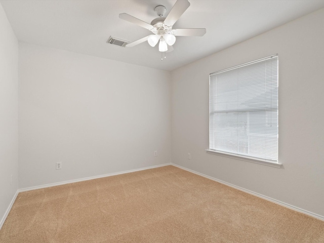 carpeted empty room featuring ceiling fan