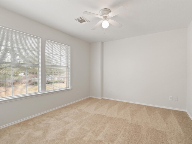 carpeted empty room featuring ceiling fan