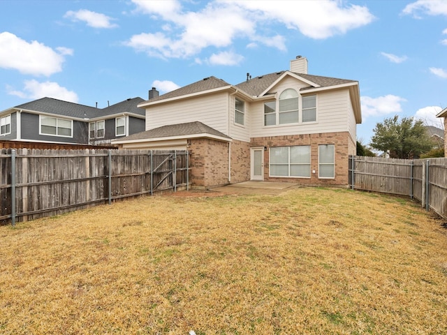 back of house featuring a patio and a lawn