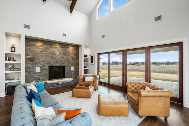 living room with wood-type flooring, a fireplace, built in features, and a rural view