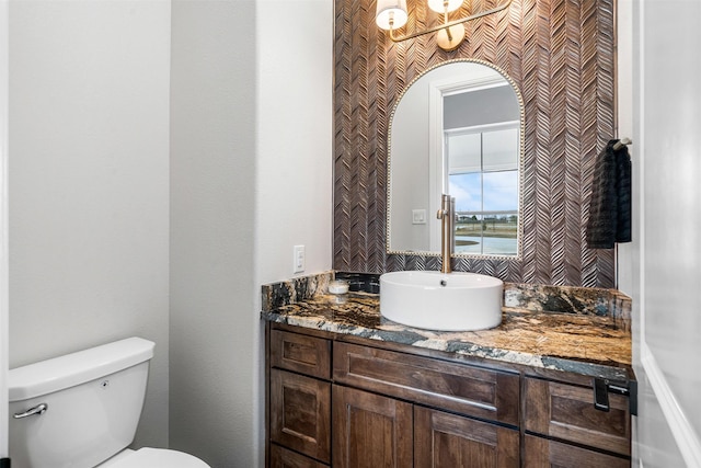 bathroom featuring a water view, vanity, and toilet