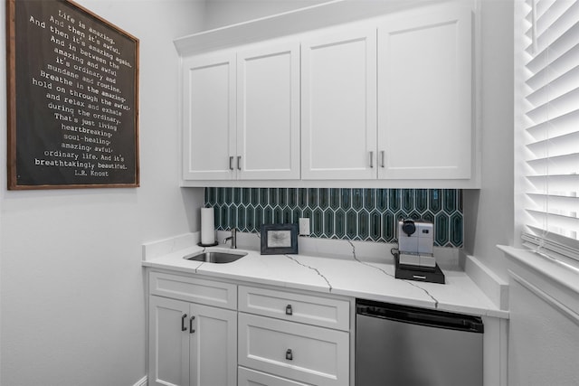 kitchen featuring light stone counters, fridge, dishwasher, and white cabinets