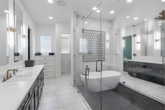 bathroom featuring vanity and independent shower and bath