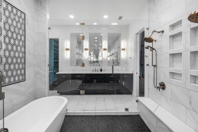 bathroom featuring a tile shower, a freestanding bath, vanity, and recessed lighting