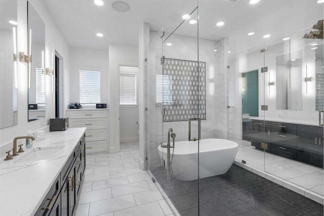 bathroom with recessed lighting, a freestanding tub, vanity, and a stall shower