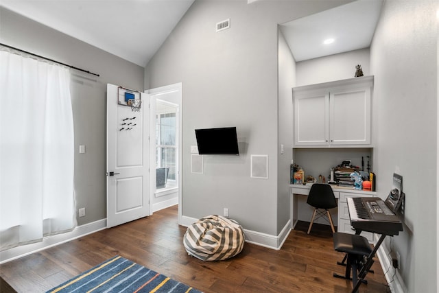 office area with visible vents, baseboards, dark wood-style floors, vaulted ceiling, and built in study area