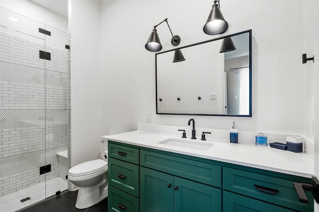 full bathroom featuring toilet, vanity, a shower stall, and tile patterned flooring