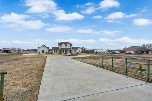 view of front of house with a fenced front yard and a gate