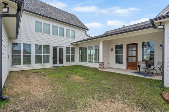 rear view of property with a patio, french doors, and a yard
