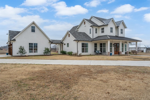 view of front of house with a porch and a front yard