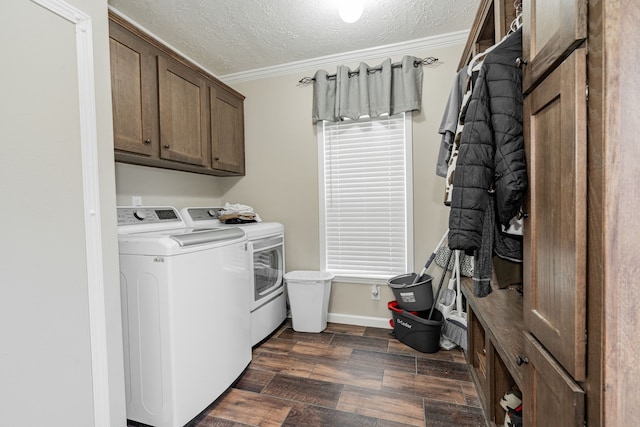 washroom with crown molding, cabinets, washer and dryer, a textured ceiling, and dark hardwood / wood-style flooring