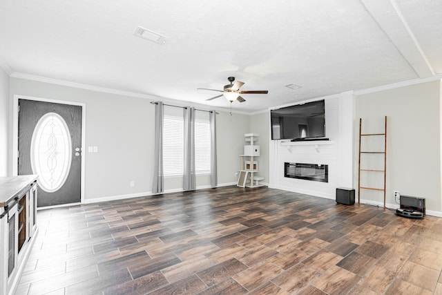 unfurnished living room featuring dark hardwood / wood-style flooring, a healthy amount of sunlight, and a fireplace