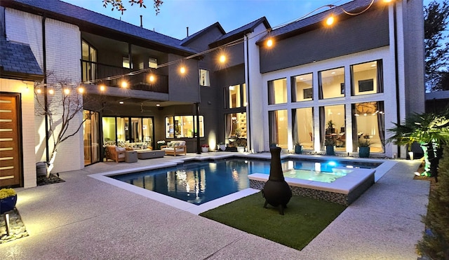 view of pool with a pool with connected hot tub, outdoor lounge area, and a patio