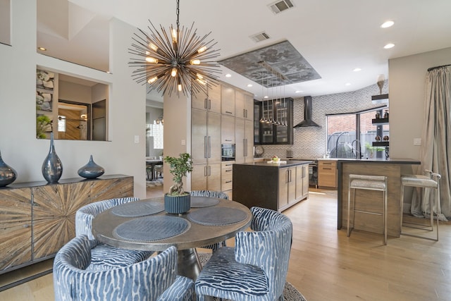 dining room featuring a notable chandelier, visible vents, recessed lighting, and light wood-type flooring