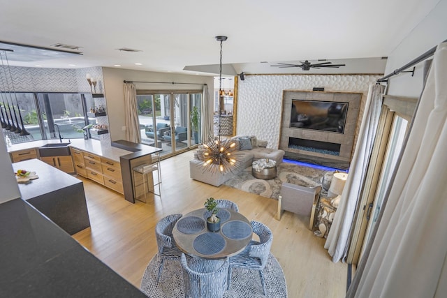 kitchen with visible vents, light wood-style flooring, wallpapered walls, and open floor plan