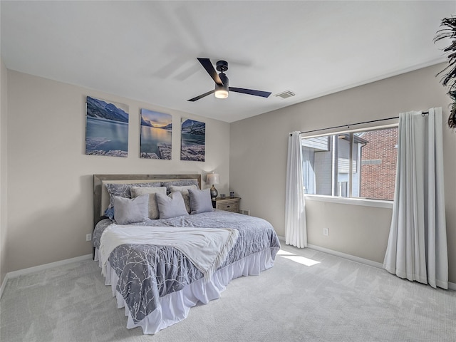 carpeted bedroom featuring a ceiling fan, baseboards, and visible vents