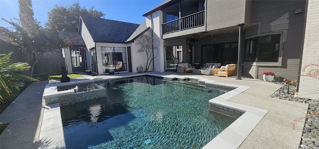 outdoor pool with an outdoor hangout area, fence, and a patio area