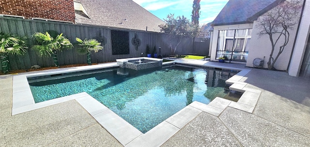 view of pool with a patio area, a fenced backyard, and a pool with connected hot tub