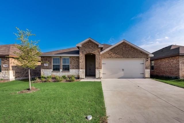 view of front of property with a garage and a front lawn