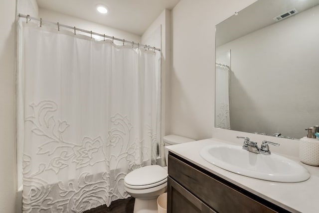 full bathroom featuring vanity, shower / bath combo, and toilet