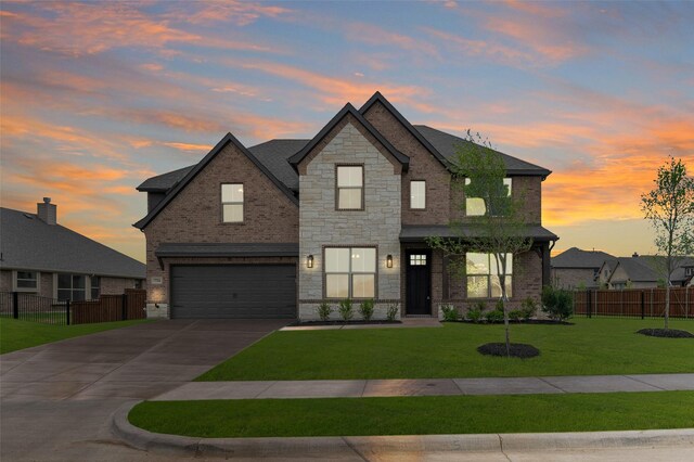view of front of property with a garage, brick siding, fence, and a front lawn