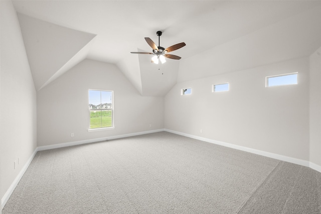 additional living space featuring ceiling fan, baseboards, vaulted ceiling, and carpet floors