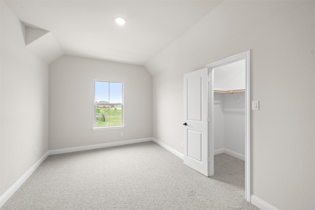bonus room featuring baseboards, vaulted ceiling, and carpet flooring