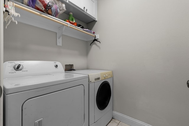 laundry room with cabinets and washer and dryer