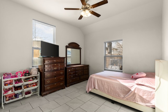 tiled bedroom with ceiling fan, vaulted ceiling, and multiple windows